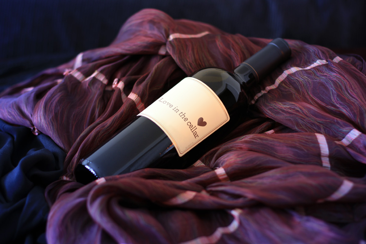 A bottle of wine on a beautiful rich velvet blanket